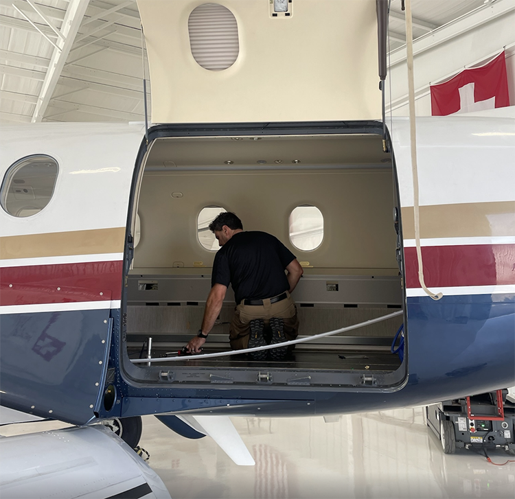 Man refurbishing the interior of a Pilatus PC-12 Aircraft at JetSwiss aviation